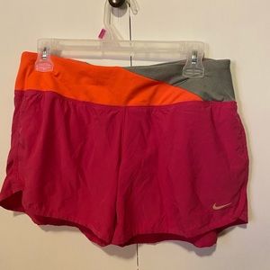 Pink nike shorts with orange and grey waist